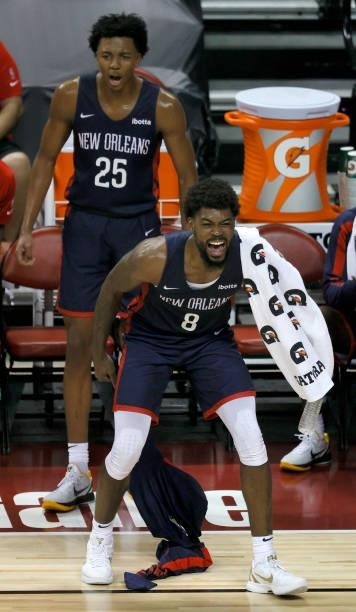 Trey Murphy III and Naji Marshall of the New Orleans Pelicans react from the bench after a teammate scored against the Cleveland Cavaliers during the...