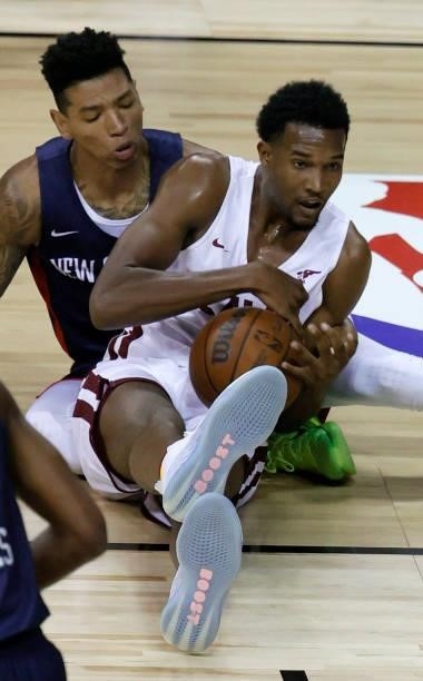 Evan Mobley of the Cleveland Cavaliers grabs a loose ball against Didi Louzada of the New Orleans Pelicans during the 2021 NBA Summer League at the...