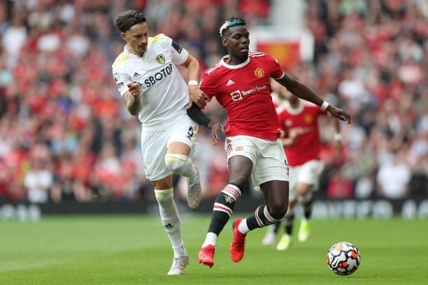 Paul Pogba of Manchester United is challenged by Robin Koch of Leeds United during the Premier League match between Manchester United and Leeds...
