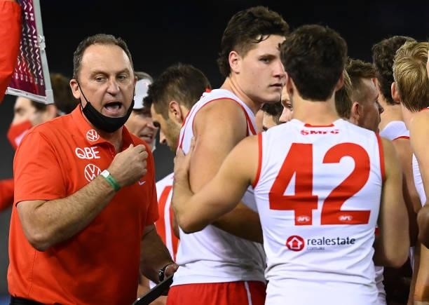Swans head coach John Longmire talks to his players during the round 22 AFL match between North Melbourne Kangaroos and Sydney Swans at Marvel...