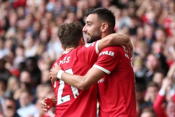 Bruno Fernandes of Manchester United celebrates with teammate Daniel James after scoring their side's first goal during the Premier League match...