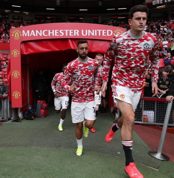 Bruno Fernandes and Harry Maguire of Manchester United warms up ahead of the Premier League match between Manchester United and Leeds United at Old...