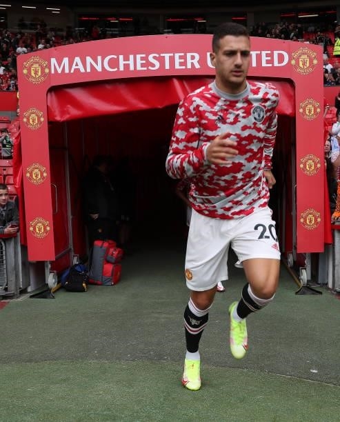 Diogo Dalot of Manchester United warms up ahead of the Premier League match between Manchester United and Leeds United at Old Trafford on August 14,...