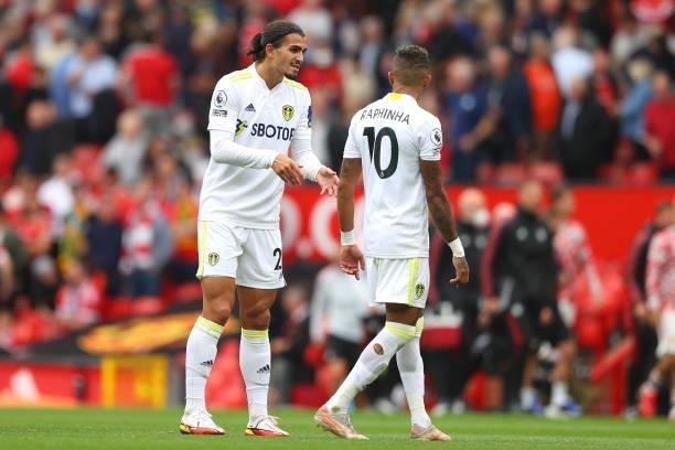 Pascal Struijk of Leeds United speaks with Raphinha of Leeds as they walk off the pitch at half time during the Premier League match between...