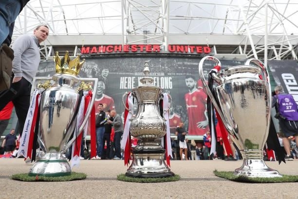 Replica Premier League, FA Cup and Champions League trophies are displayed outside the stadium prior to the Premier League match between Manchester...