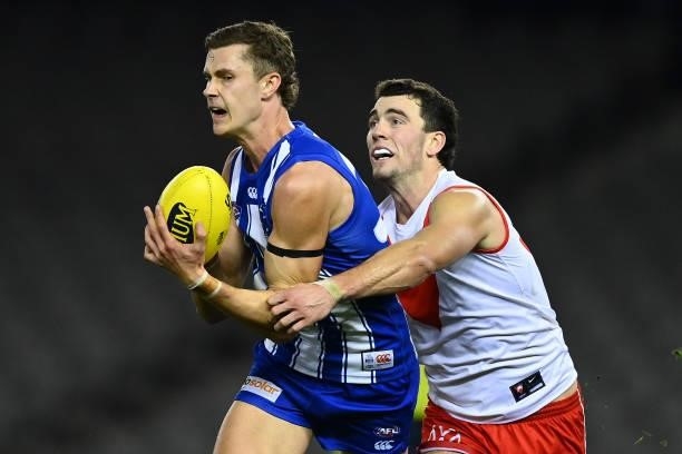 Charlie Comben of the Kangaroos marks infront of Tom McCartin of the Swans during the round 22 AFL match between North Melbourne Kangaroos and Sydney...