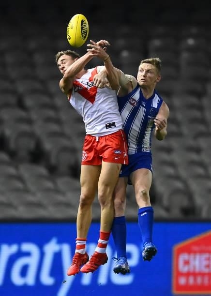 Jack Ziebell of the Kangaroos spoils a mark by Will Hayward of the Swans during the round 22 AFL match between North Melbourne Kangaroos and Sydney...