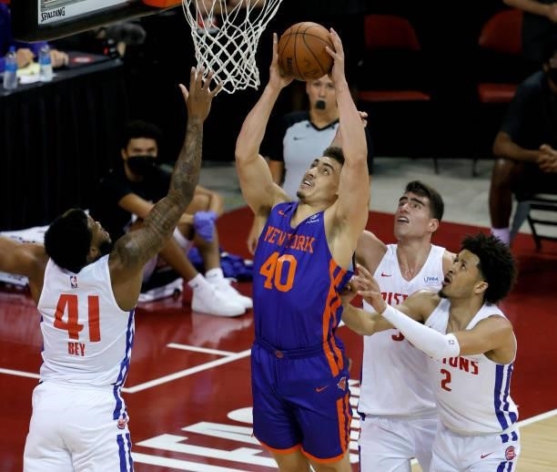 Reid Travis of the New York Knicks shoots against Saddiq Bey, Luka Garza and Cade Cunningham of the Detroit Pistons during the 2021 NBA Summer League...