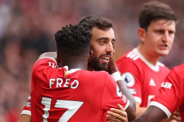 Bruno Fernandes of Manchester United celebrates with teammate Fred after scoring their side's third goal during the Premier League match between...