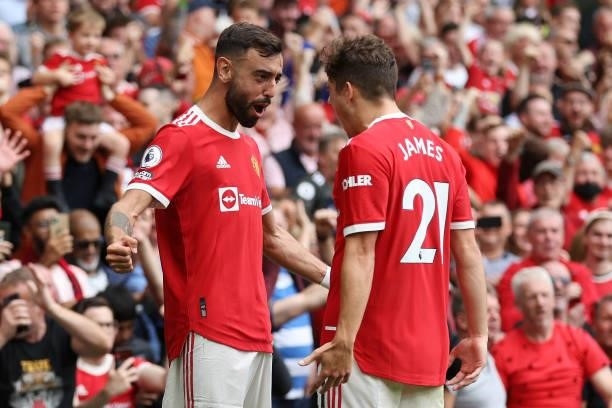 Bruno Fernandes of Manchester United celebrates with teammate Daniel James after scoring their side's fourth goal and his hat-trick during the...