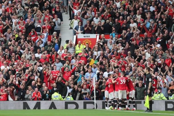 Fans celebrate the fourth goal scored by Bruno Fernandes of Manchester United and his hat-trick during the Premier League match between Manchester...