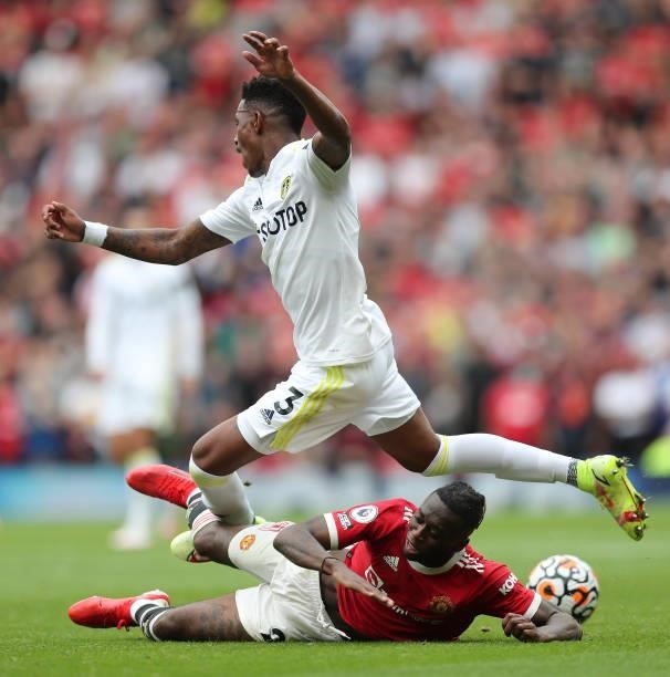 Junior Firpo of Leeds United is tackled by Aaron Wan-Bissaka of Manchester United during the Premier League match between Manchester United and Leeds...