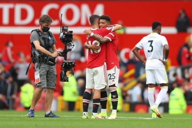 Bruno Fernandes of Manchester United and teammate Jadon Sancho embrace following victory in the Premier League match between Manchester United and...