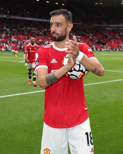 Bruno Fernandes of Manchester United walks off with the match ball after the Premier League match between Manchester United and Leeds United at Old...