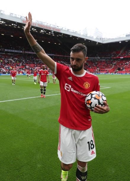 Bruno Fernandes of Manchester United walks off with the match ball after the Premier League match between Manchester United and Leeds United at Old...