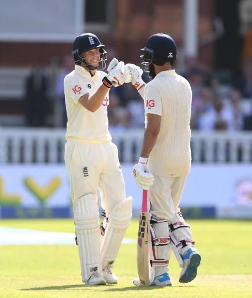 England batsman Joe Root celebrates his 150 with Moeen Ali during day three of the Second Test Match between England and India at Lord's Cricket...