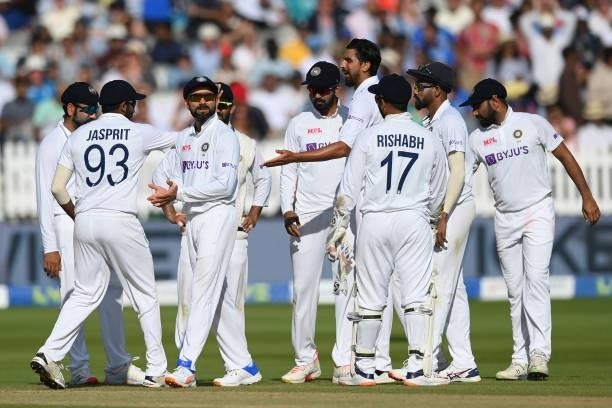 Virat Kohli and his teammates wait for confirmation on his low catch to dismiss Moeen Ali of England during the Second LV= Insurance Test Match: Day...