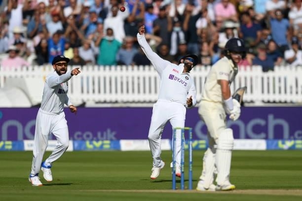 Rohit Sharma of India throws the ball high after taking a catch to dismiss Sam Curran of England first ball as Virat Kohli celebrates during the...
