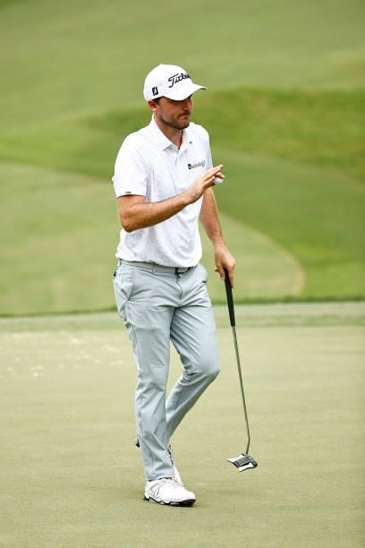 Russell Henley of the United States waves on the fifth green during the third round of the Wyndham Championship at Sedgefield Country Club on August...