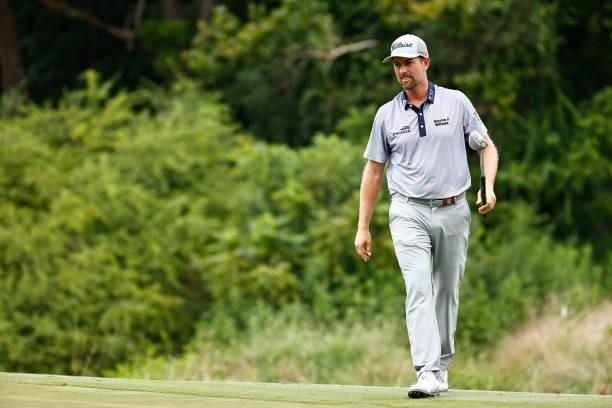 Webb Simpson of the United States looks on from the seventh green during the third round of the Wyndham Championship at Sedgefield Country Club on...