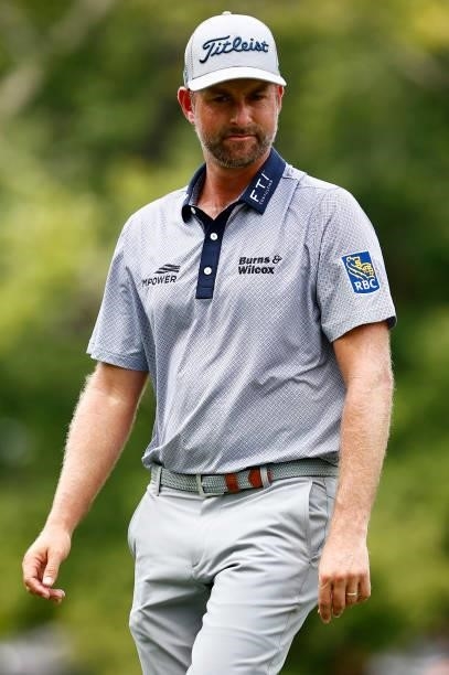 Webb Simpson of the United States looks on from the seventh green during the third round of the Wyndham Championship at Sedgefield Country Club on...
