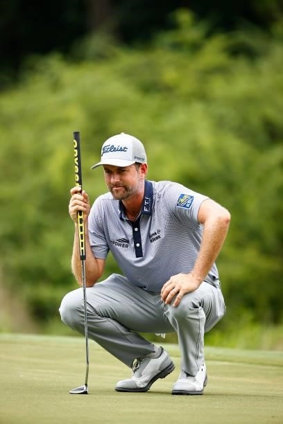 Webb Simpson of the United States lines up a putt on the seventh green during the third round of the Wyndham Championship at Sedgefield Country Club...