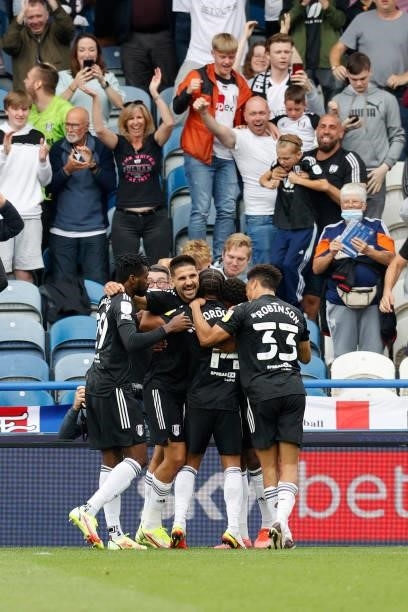 Ivan Cavaleiro of Fulham celebrates with team mates in front of the traveling fans after scoring during the Sky Bet Championship match between...