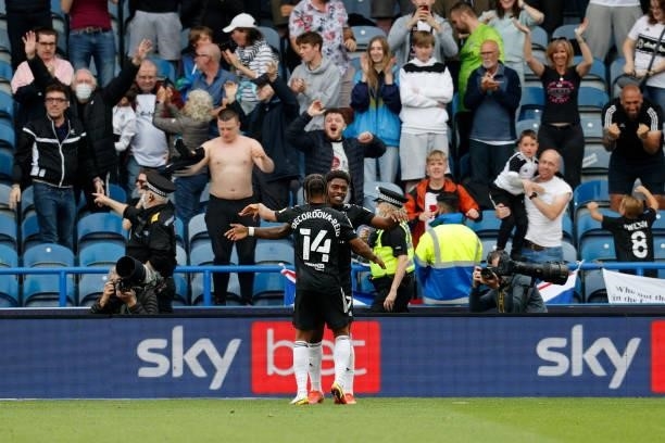 Ivan Cavaleiro of Fulham celebrates with team mate Bobby De Cordova-Reid in front of the traveling fans after scoring during the Sky Bet Championship...