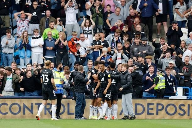 Ivan Cavaleiro of Fulham celebrates with team mates in front of the traveling fans after scoring during the Sky Bet Championship match between...
