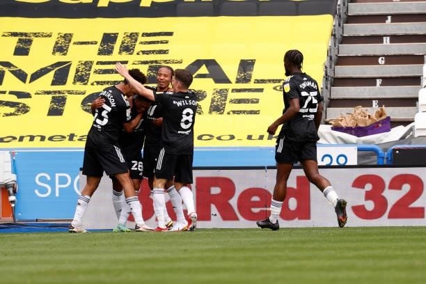 Fulham players celebrate with team mate Fabio Carvalho after scoring during the Sky Bet Championship match between Huddersfield Town and Fulham at...