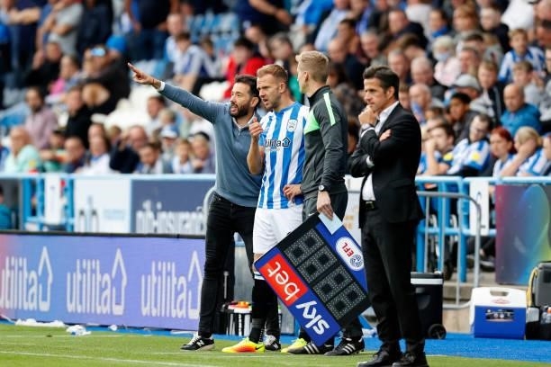 Carlos Coberán the Head Coach of Huddersfield Town gives last bits of coaching to new substitute Jordan Rhodes during the Sky Bet Championship match...