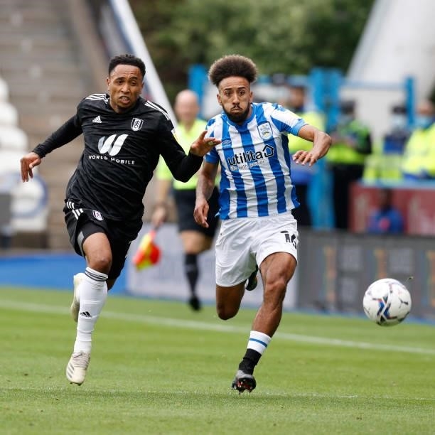 Sorba Thomas of Huddersfield Town and Kenny Tete of Fulham chase a bouncing ball during the Sky Bet Championship match between Huddersfield Town and...