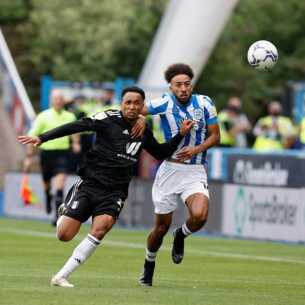 Sorba Thomas of Huddersfield Town and Kenny Tete of Fulham chase a bouncing ball during the Sky Bet Championship match between Huddersfield Town and...