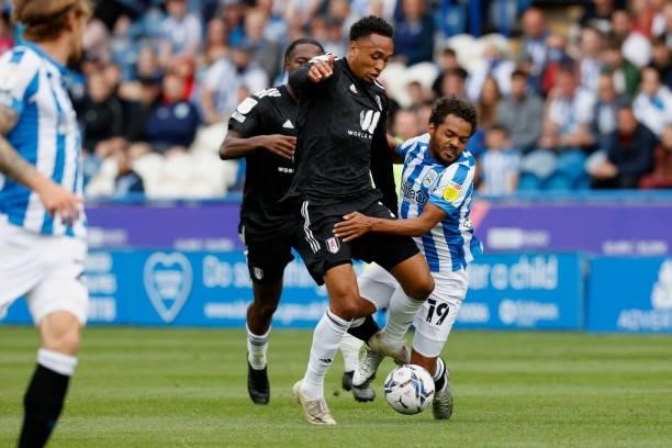 Kenny Tete of Fulham battles with Duane Holmes of Huddersfield Town during the Sky Bet Championship match between Huddersfield Town and Fulham at...