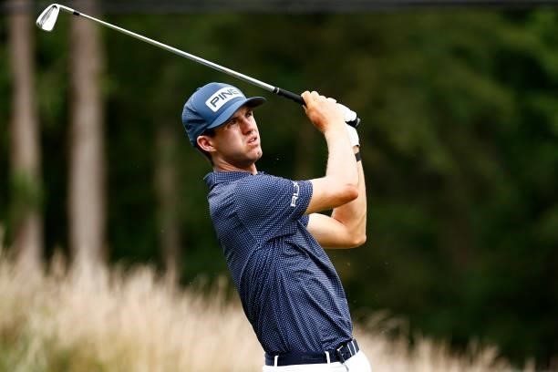 Alex Smalley of the United States plays his shot from the 12th tee during the third round of the Wyndham Championship at Sedgefield Country Club on...