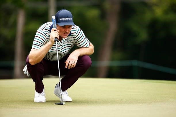 Justin Rose of England lines up a putt on the 11th green during the third round of the Wyndham Championship at Sedgefield Country Club on August 14,...