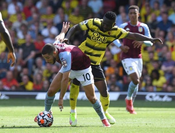 Peter Etebo of Watford challenges Emiliano Buendia of Aston Villa during the Premier League match between Watford and Aston Villa at Vicarage Road on...