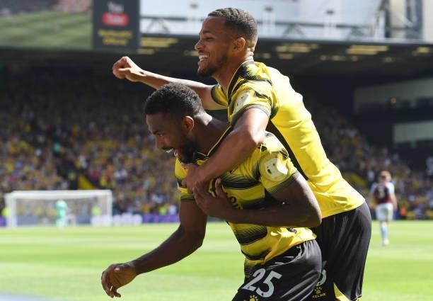 Emmanuel Dennis of Watford celebrates scoring their first goal with William Troost-Ekong of Watford during the Premier League match between Watford...