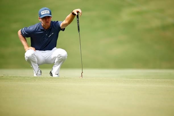 Alex Smalley of the United States prepares to putt on the 11th hole during the third round of the Wyndham Championship at Sedgefield Country Club on...