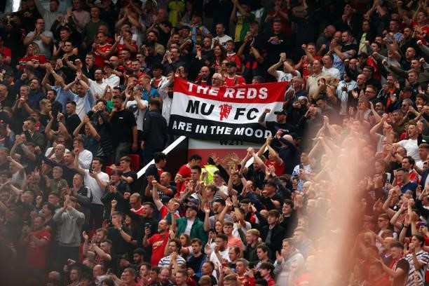 Fans of Manchester United hold up a banner during the Premier League match between Manchester United and Leeds United at Old Trafford on August 14,...