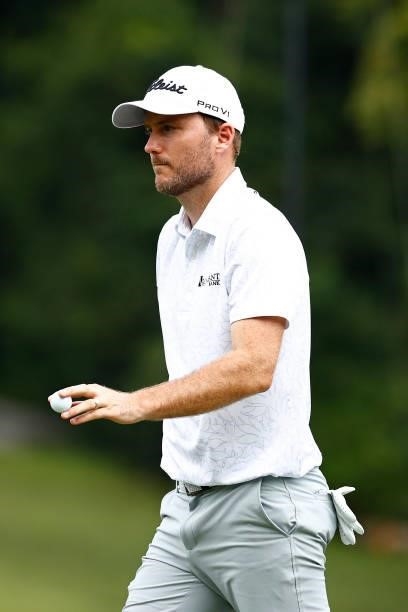 Russell Henley of the United States waves on the seventh green during the third round of the Wyndham Championship at Sedgefield Country Club on...