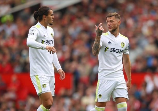Liam Cooper of Leeds United talks to Pascal Struijk during the Premier League match between Manchester United and Leeds United at Old Trafford on...