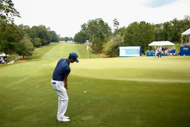 Alex Smalley of the United States chips to the 18th green during the third round of the Wyndham Championship at Sedgefield Country Club on August 14,...