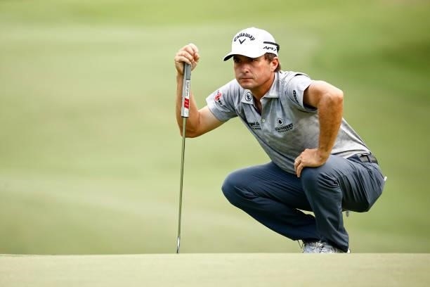 Kevin Kisner of the United States lines up a putt on the 17th green during the third round of the Wyndham Championship at Sedgefield Country Club on...