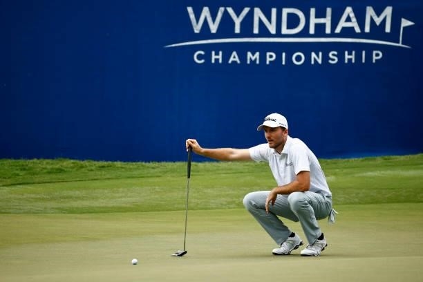 Russell Henley of the United States lines up his putt on the 18th green during the third round of the Wyndham Championship at Sedgefield Country Club...