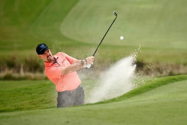 Rory Sabbatini of Slovakia plays a shot from a greenside bunker on the 18th hole during the third round of the Wyndham Championship at Sedgefield...