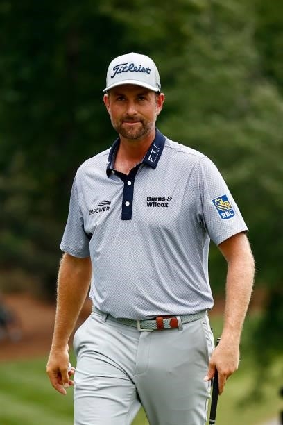 Webb Simpson of the United States reacts after making his second chip on the 18th green for par during the third round of the Wyndham Championship at...