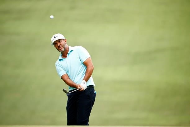 Scott Piercy of the United States chips to the 18th green during the third round of the Wyndham Championship at Sedgefield Country Club on August 14,...