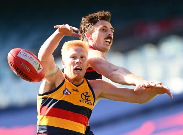Elliott Himmelberg of the Crows and Jake Lever of the Demons compete for the ball during the round 22 AFL match between Melbourne Demons and Adelaide...