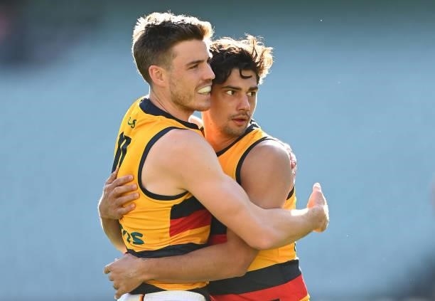 Shane McAdam of the Crows is congratulated by Paul Seedsman after kicking a goal during the round 22 AFL match between Melbourne Demons and Adelaide...